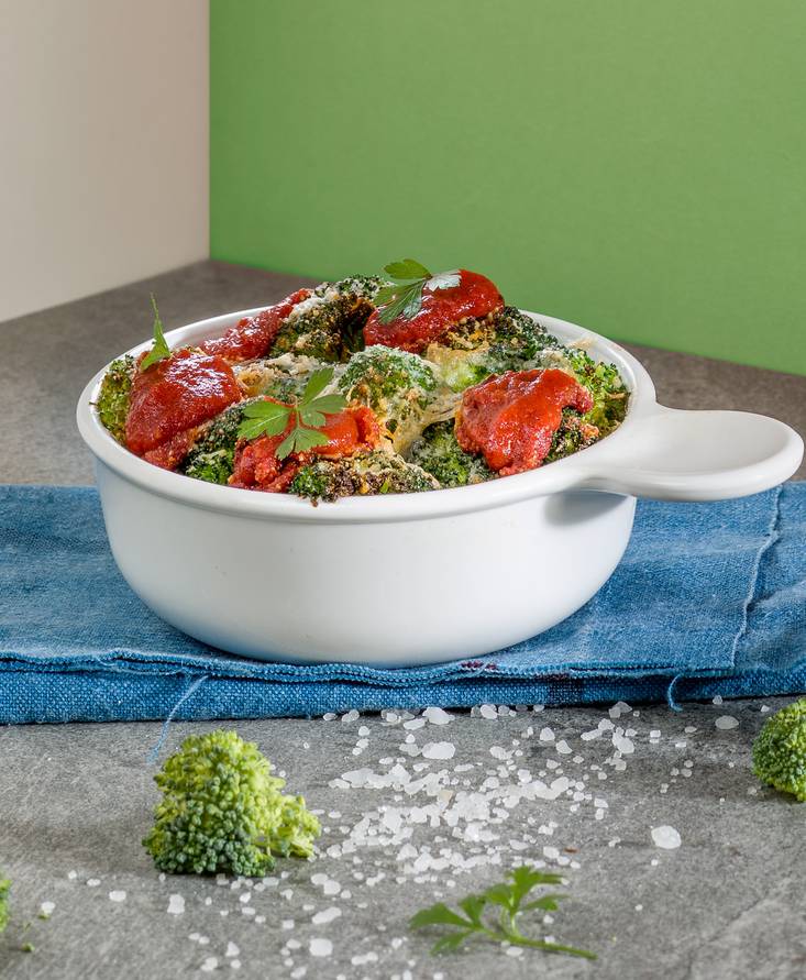 Baby broccoli in tomato sauce and taleggio cheese au gratin